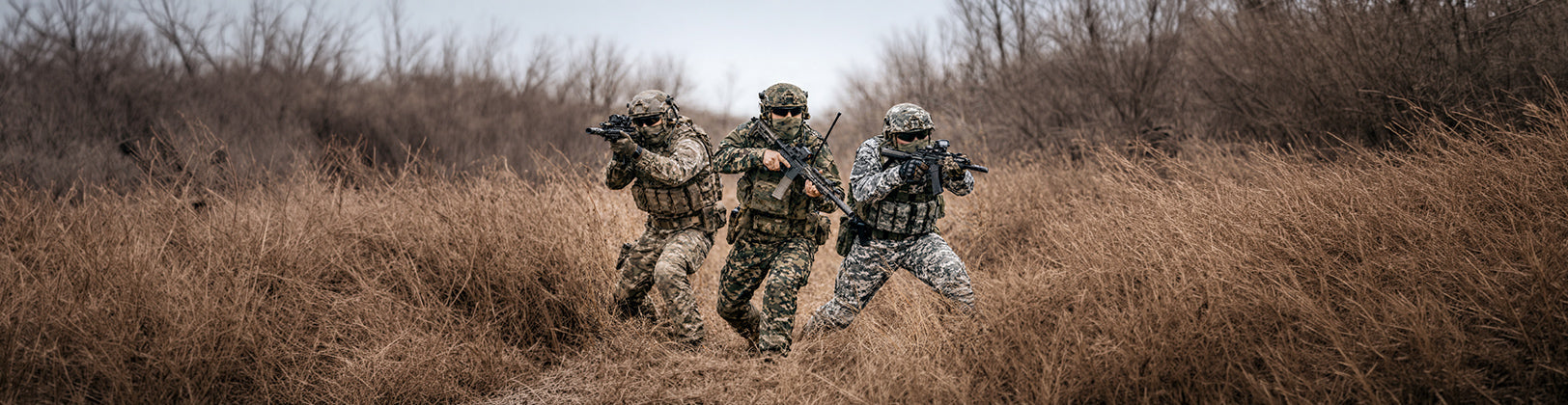 Soldiers in combat uniforms engineered with 2D garment design for durability, mobility, and performance in field conditions